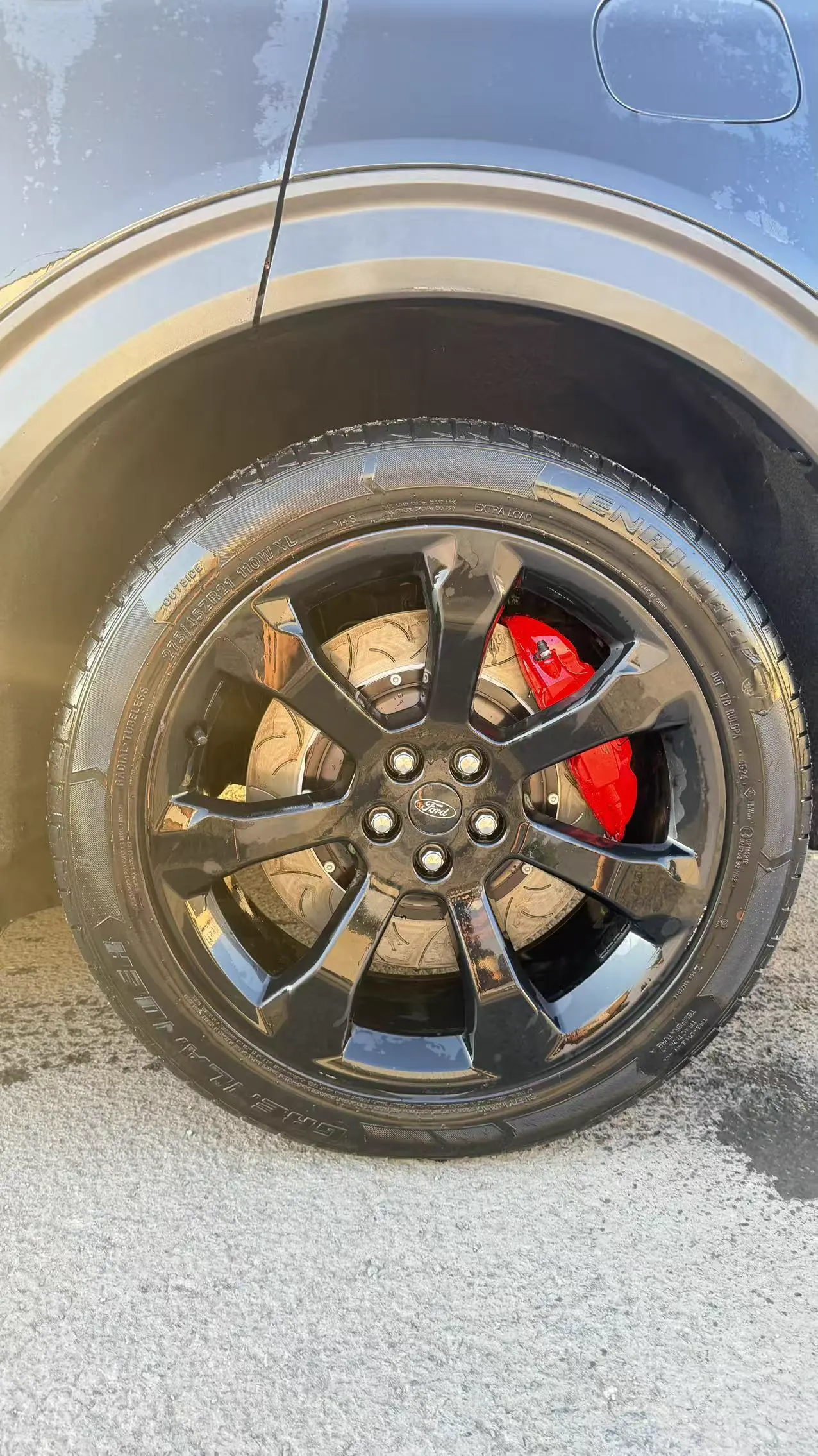 Customer vehicle wheel showing the installed red brake caliper and rotor