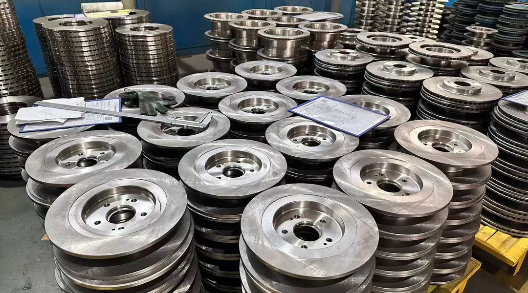 Stacks of brake discs in the workshop, staged for turning and surface preparation