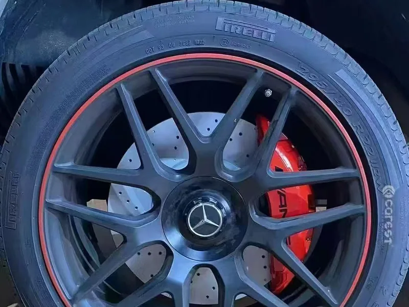 Red six-piston caliper behind an AMG alloy wheel