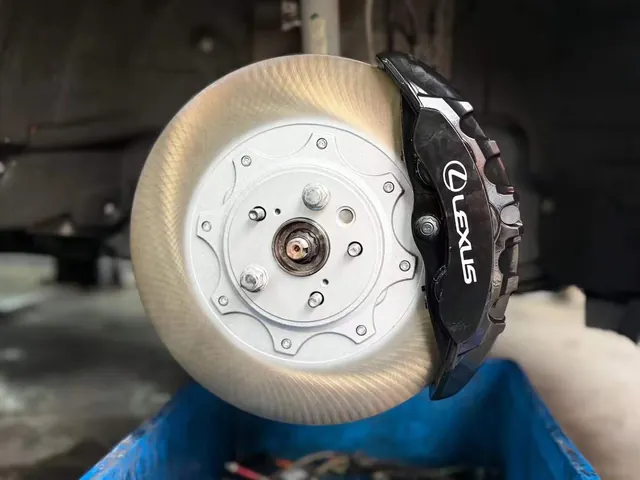 Black Lexus-marked front caliper and rotor in the RX300 installation set