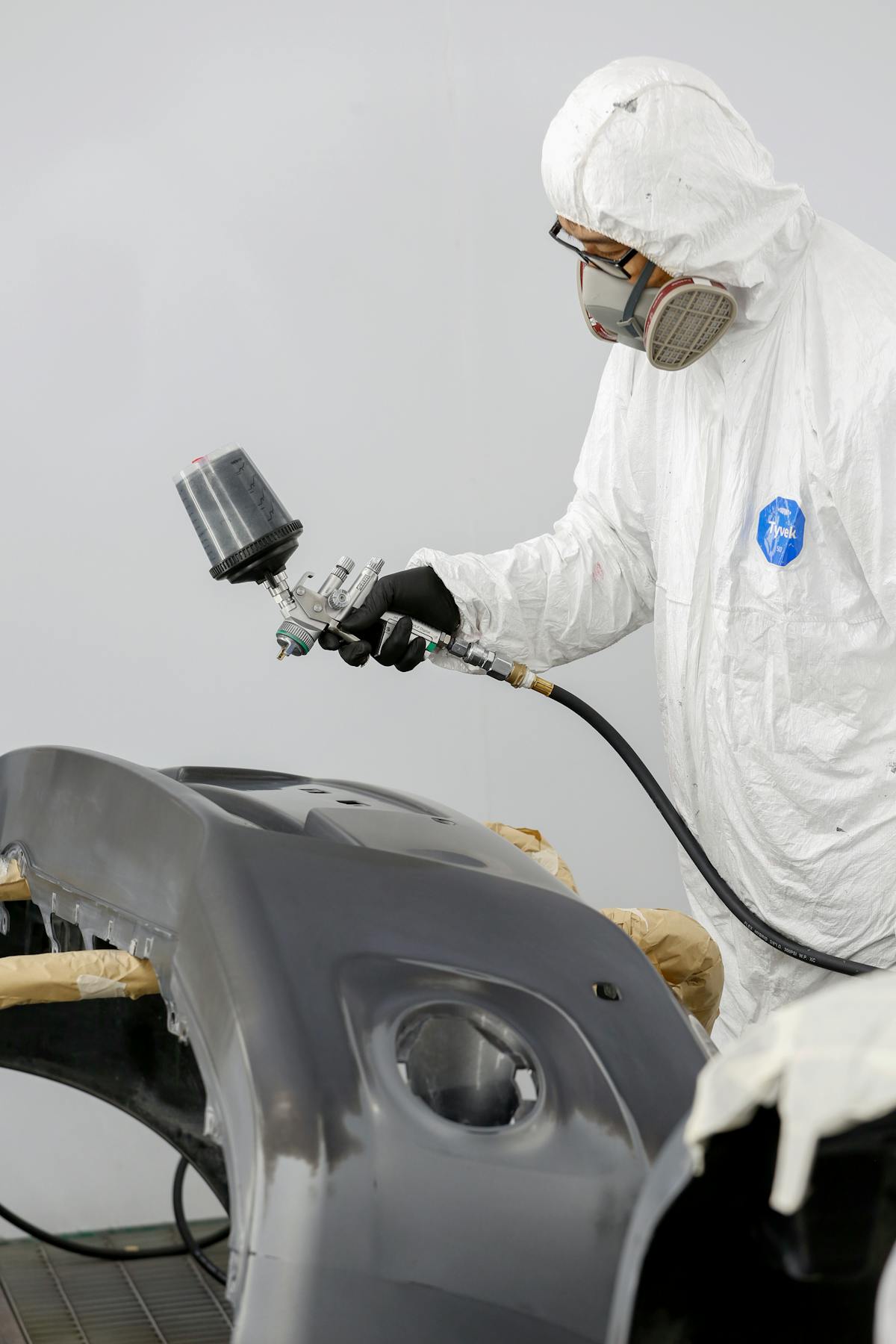 Paint preparation for an automotive bumper in a repair workshop