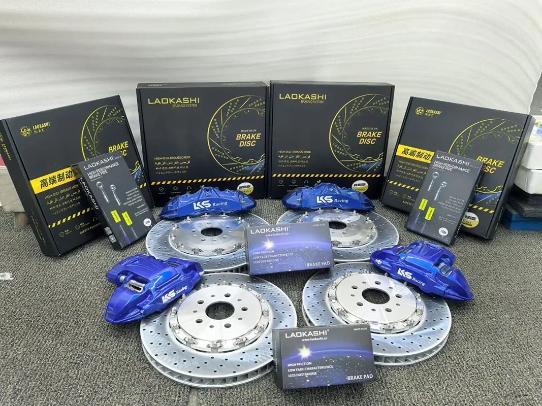 Front brake caliper kit with blue calipers, drilled rotors, pads and brake-disc packaging