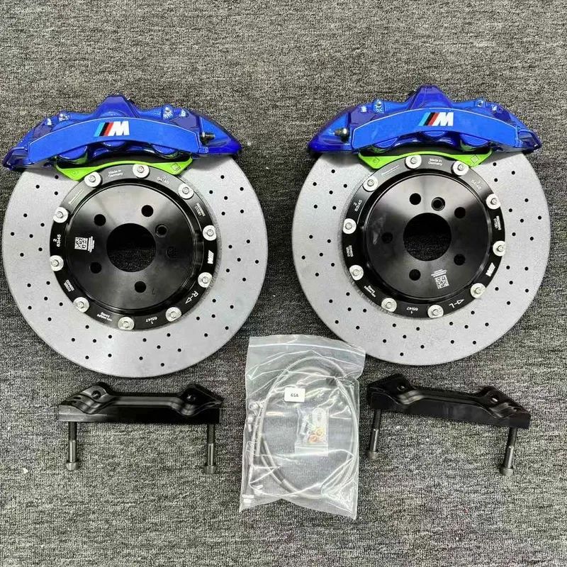 Close view of a front six-piston caliper, adapter bracket and ventilated rotor for BMW G20 fitment review.