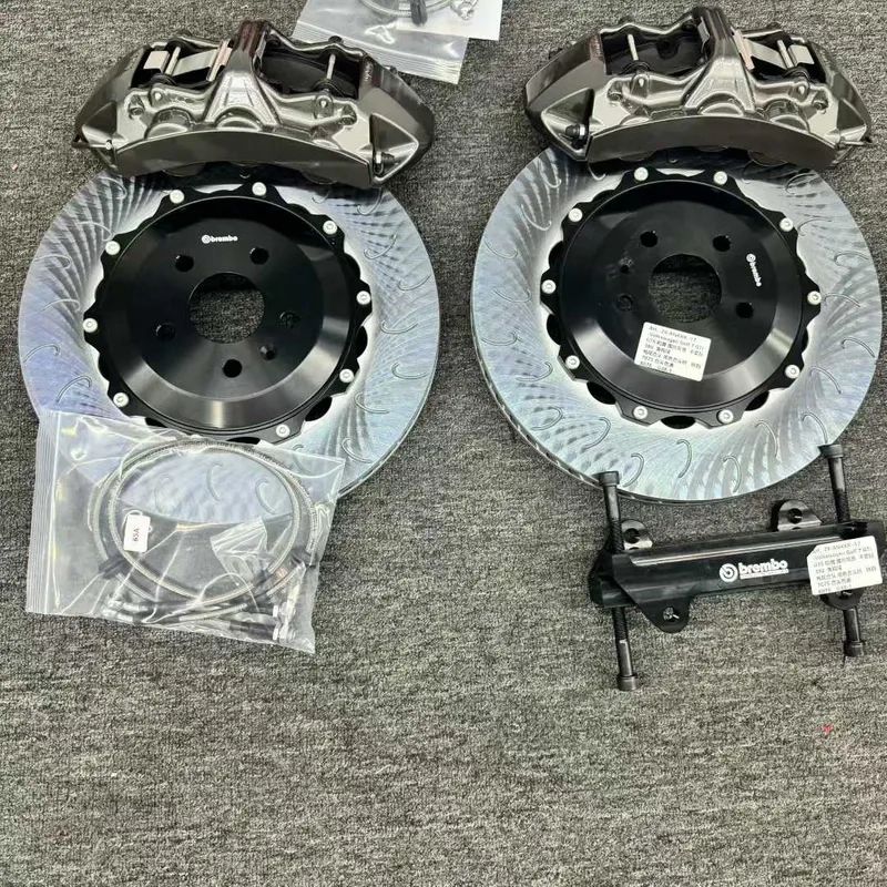 Close detail of a front six-piston caliper, adapter bracket and ventilated rotor for E60 fitment review.