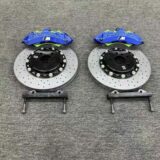Close view of a GT6 six-piston front caliper, adapter bracket and rotor interface for BMW F30 fitment review.
