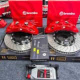 BMW E92 M3 Big Brake Kit | 19-21 Inch Fitment Review — Six-piston front caliper, adapter bracket and two-piece brake rotor shown for component inspection
