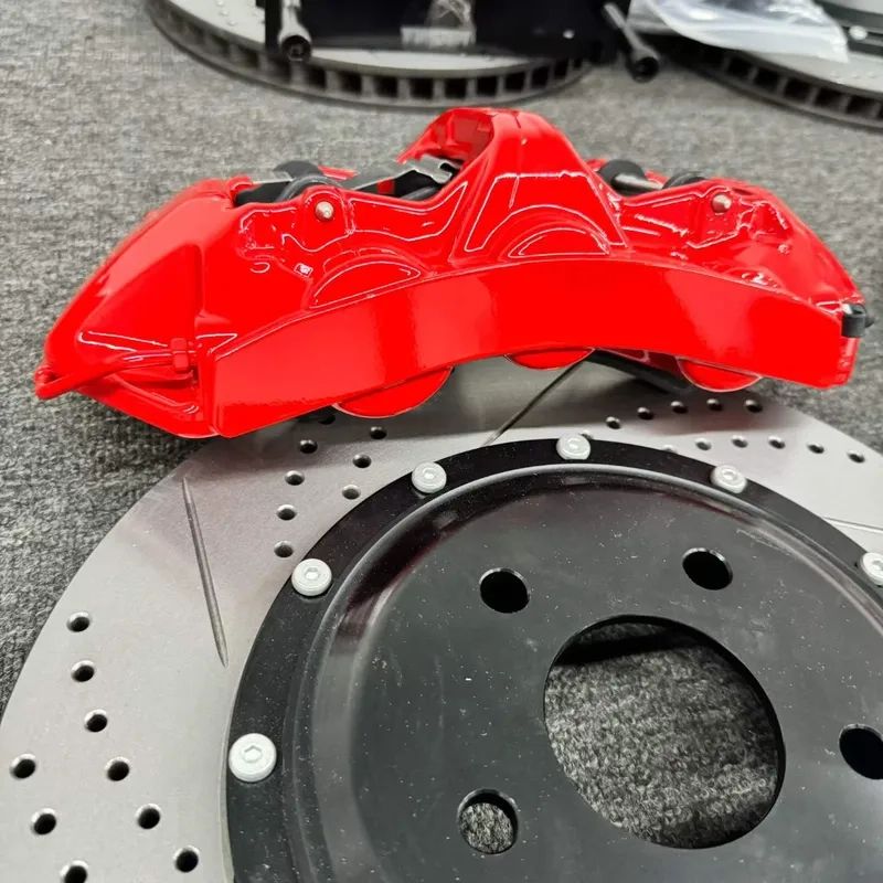 Close detail of a BMW F34 GT6 six-piston caliper and ventilated brake rotor
