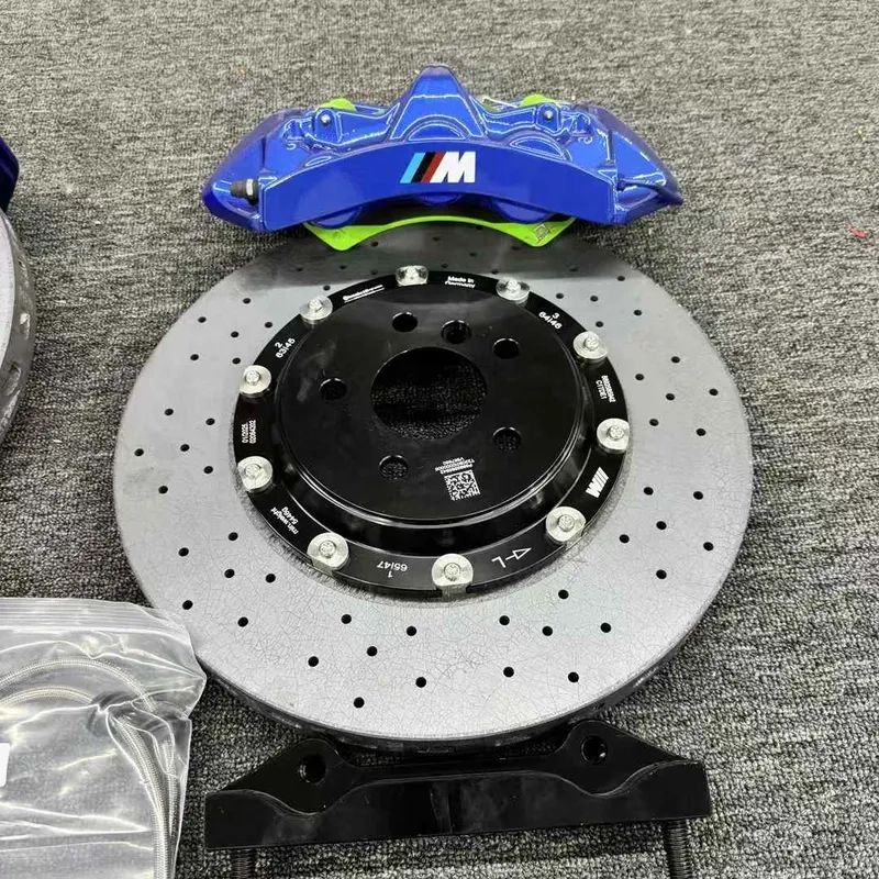 Close detail of a BMW F30 GT6 six-piston caliper and ventilated brake rotor