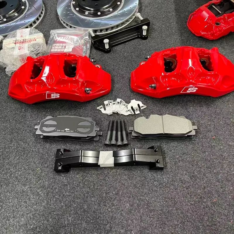 Detail view of one caliper from the BMW X5 E70 Akebono 8N front big brake kit, with the piston bores and bleed screw visible